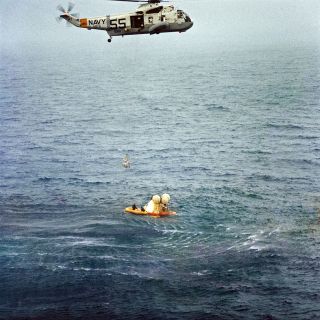 A U.S. Navy helicopter recovers the Apollo 7 crew of Wally Schirra, Donn Eisele and Walt Cunningham after their splashdown on Oct. 22, 1968. The 11-day flight tested the Apollo command and service modules in Earth orbit, paving the way to the moon.