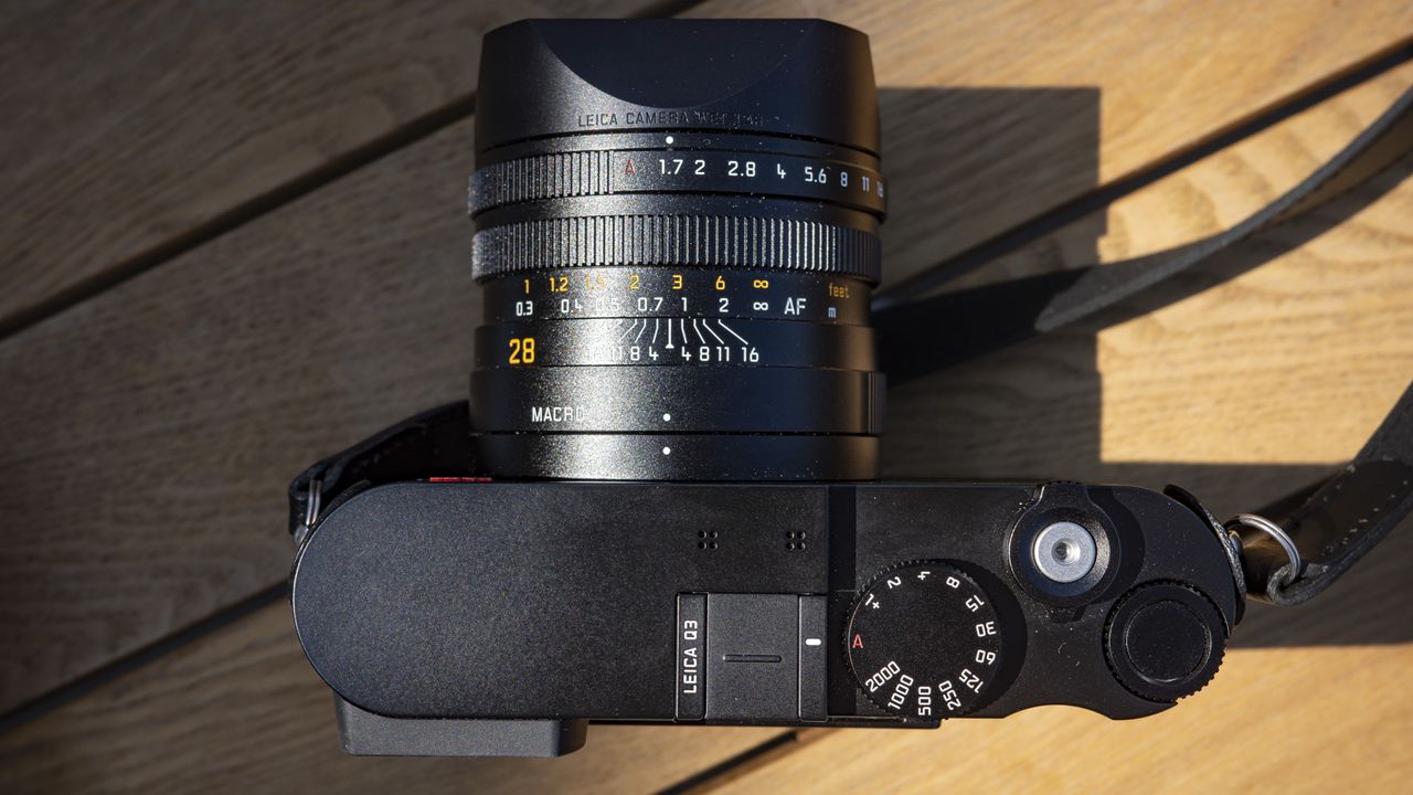 Leica Q3 camera on a wooden table view of camera top plate