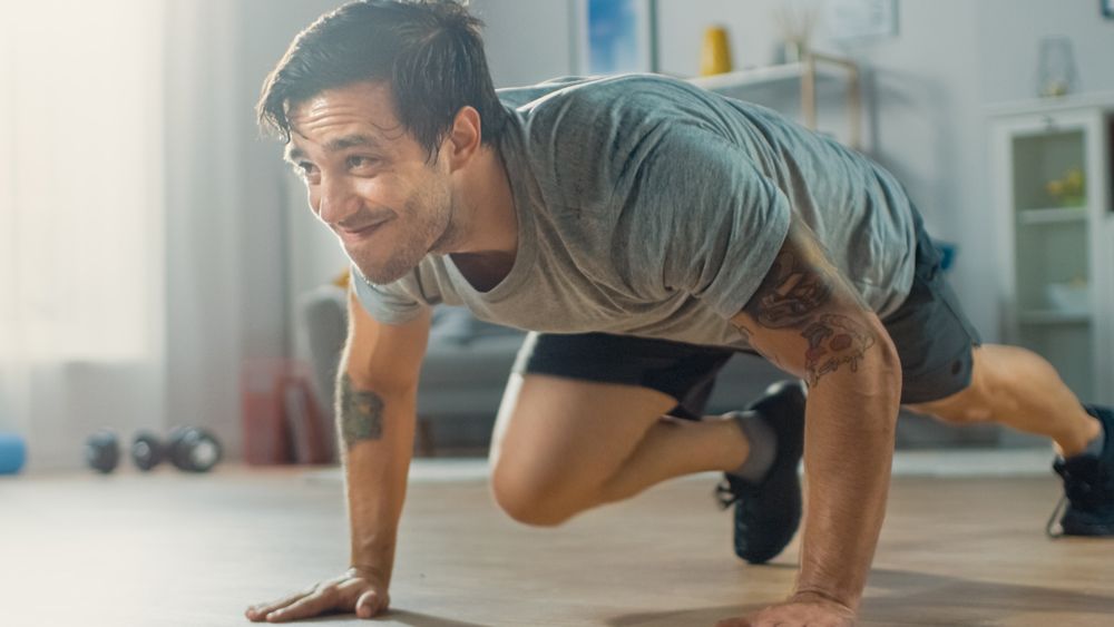 Man performing mountain climber exercise at home