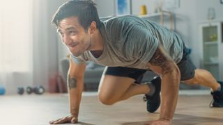 Man performing mountain climber exercise at home