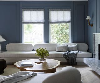 Living room with blue walls and white sofas