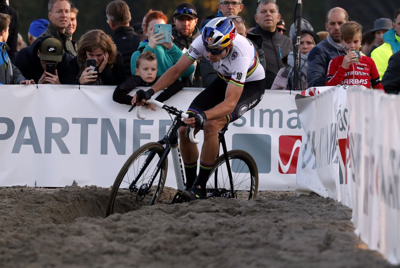 Wout van Aert rides through the sand