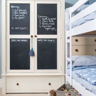 boys bedroom with bunk bed and chalkboard fronted wardrobe