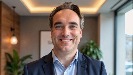 Jurgen Hofkens, chief technology officer (CTO) and vice president of sales engineering at NetApp pictured in an office space wearing a navy blue suit with light blue shirt.