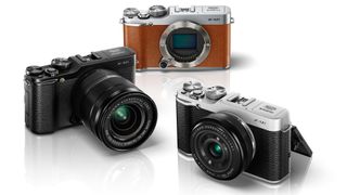 Three Fujifilm X-M1 cameras on a white background