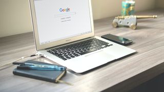 laptop open on Google on a desk