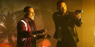 Marcus Burnett (Martin Lawrence) holds his hands out while Mike Lowrey (Will Smith) aims his gun in