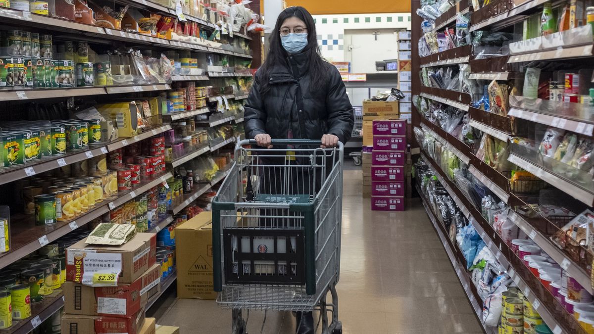 A woman wearing a surgical mask shops at a grocery store in Cupertino, California, on Jan. 23, 2020.