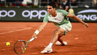 Carlos Alcaraz of Spain stretches for the ball at the 2023 French Open at Roland Garros