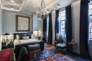 A traditional style bedroom with floor to ceiling windows