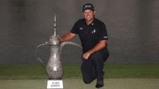 Patrick Reed poses with the Dubai Desert Classic trophy after winning in 2026