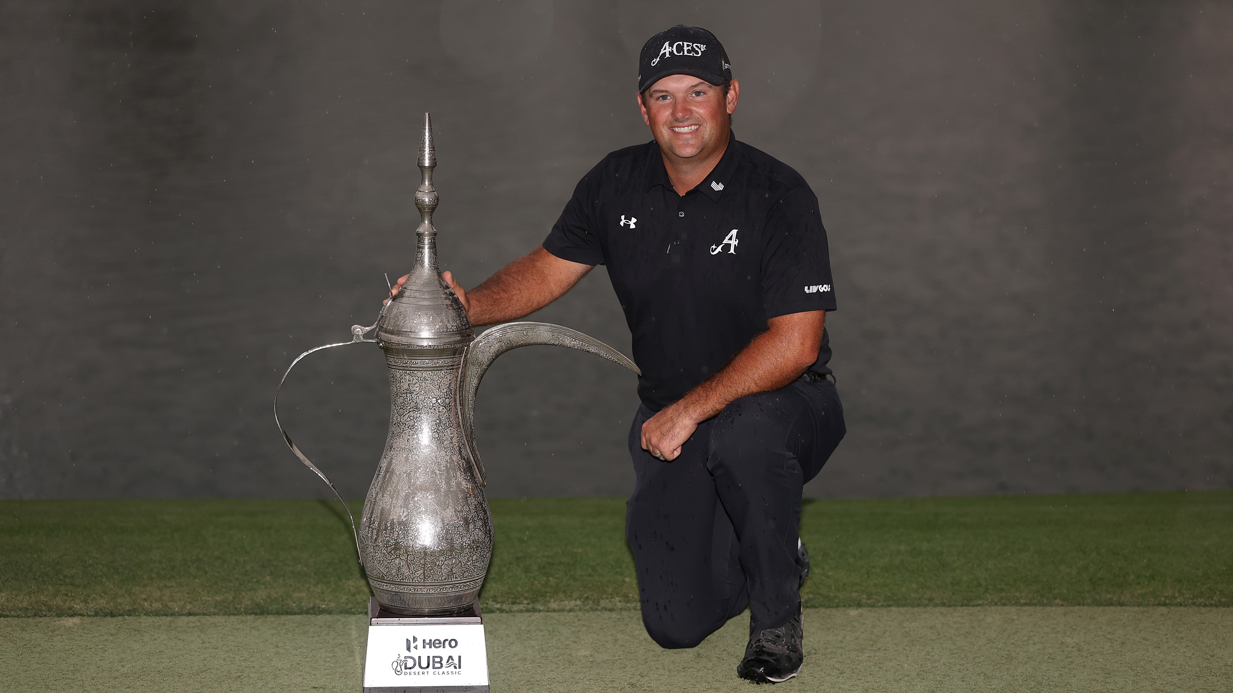 Patrick Reed poses with the Dubai Desert Classic trophy after winning in 2026
