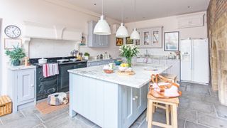 Blue Shaker-style kitchen in listed Tudor farmhouse