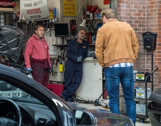 Tyrone Dobbs can't help snooping inside Phill's car.