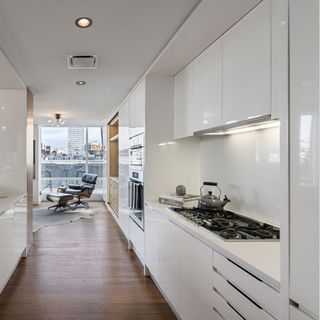 white laminated kitchen with wooden flooring