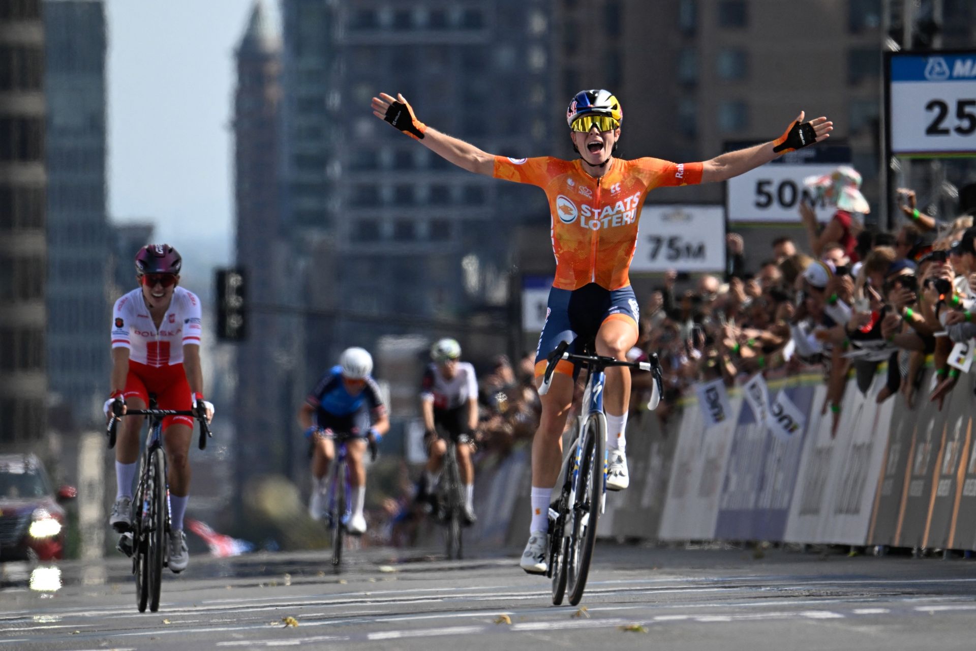 Netherlands's Demi Vollering (R) celebrates at finish line after winning the Women Elite Road Race during the 2026 Union Cycliste Internationale (UCI) Road World Championships in Montreal, Quebec, on September 26, 2026. (Photo by Andrej Ivanov / AFP via Getty Images)