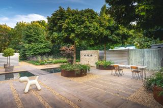 large south facing garden with paved patio, gravel paths and modern water feature