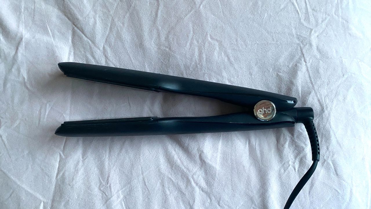 An original image of the ghd Max Styler against a pale pink fabric background
