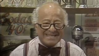 Mr. Hooper (Will Lee) sends a message in Sesame Street