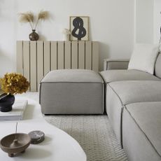 living area with white wall and sofa