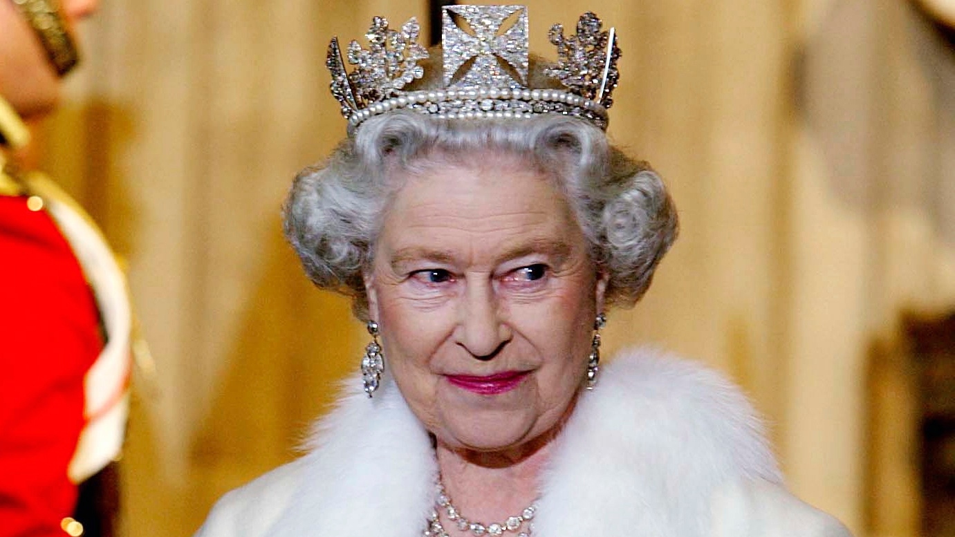 Queen Elizabeth II smiling as she arrives for the State Opening Of Parliament wearing the George IV Diadem