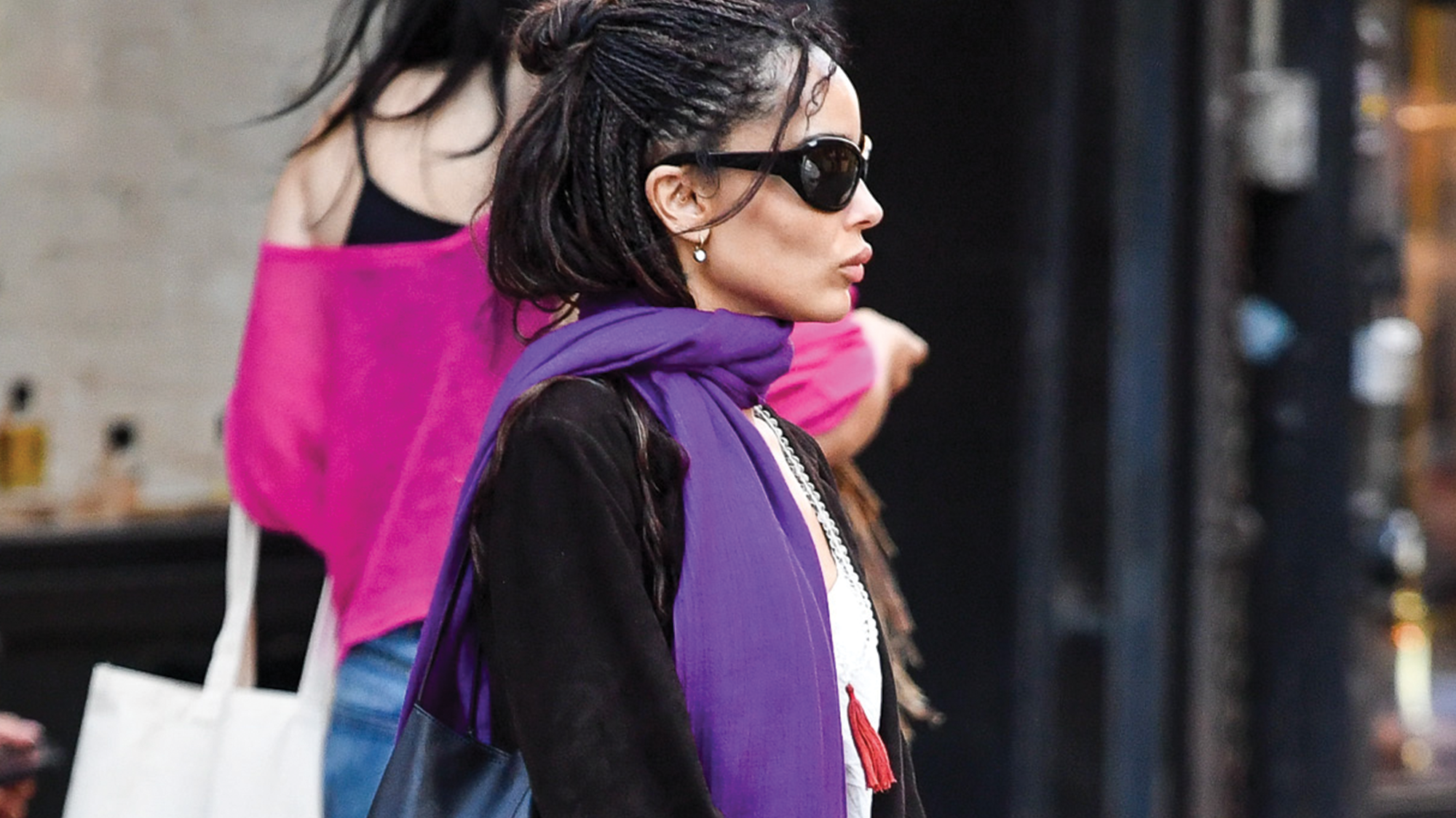 Zoe Kravitz is spotted stepping out in New York City. The 37 year old American actress wore a white top under a black coat paired with a vibrant purple scarf and black patent leather boots.