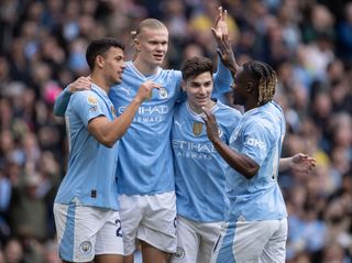Manchester City players celebrate one of their goals against Luton in a 5-1 win in the Premier League in April 2024.