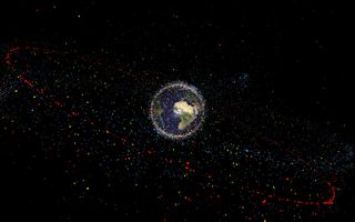 A graphic showing human-made objects in orbit around the Earth — the red dots represent satellites.