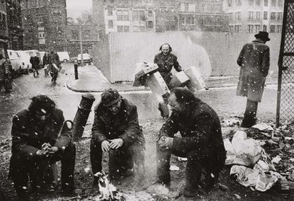 People around a fire, Spitalfields Market, London'