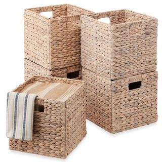 Five square wicker storage baskets with handles