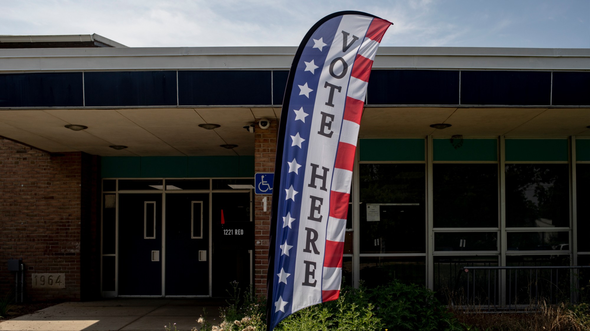 A 'Vote Here' banner is seen outside a polling place in Lansing, Michigan, in 2024. 