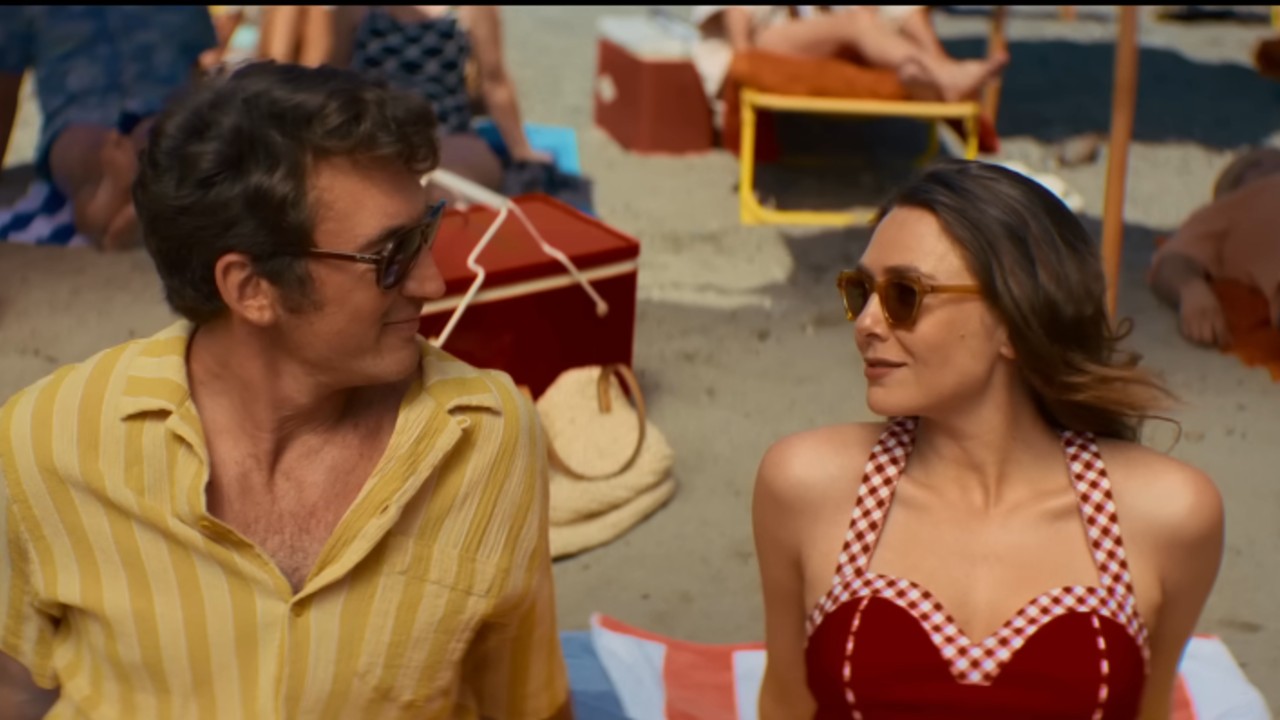 Miles Teller and Elizabeth Olsen looking at each other in Eternity. 