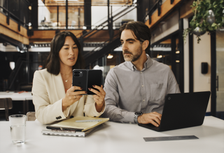 an image of two people using the Google Pixel 9 Pro Fold