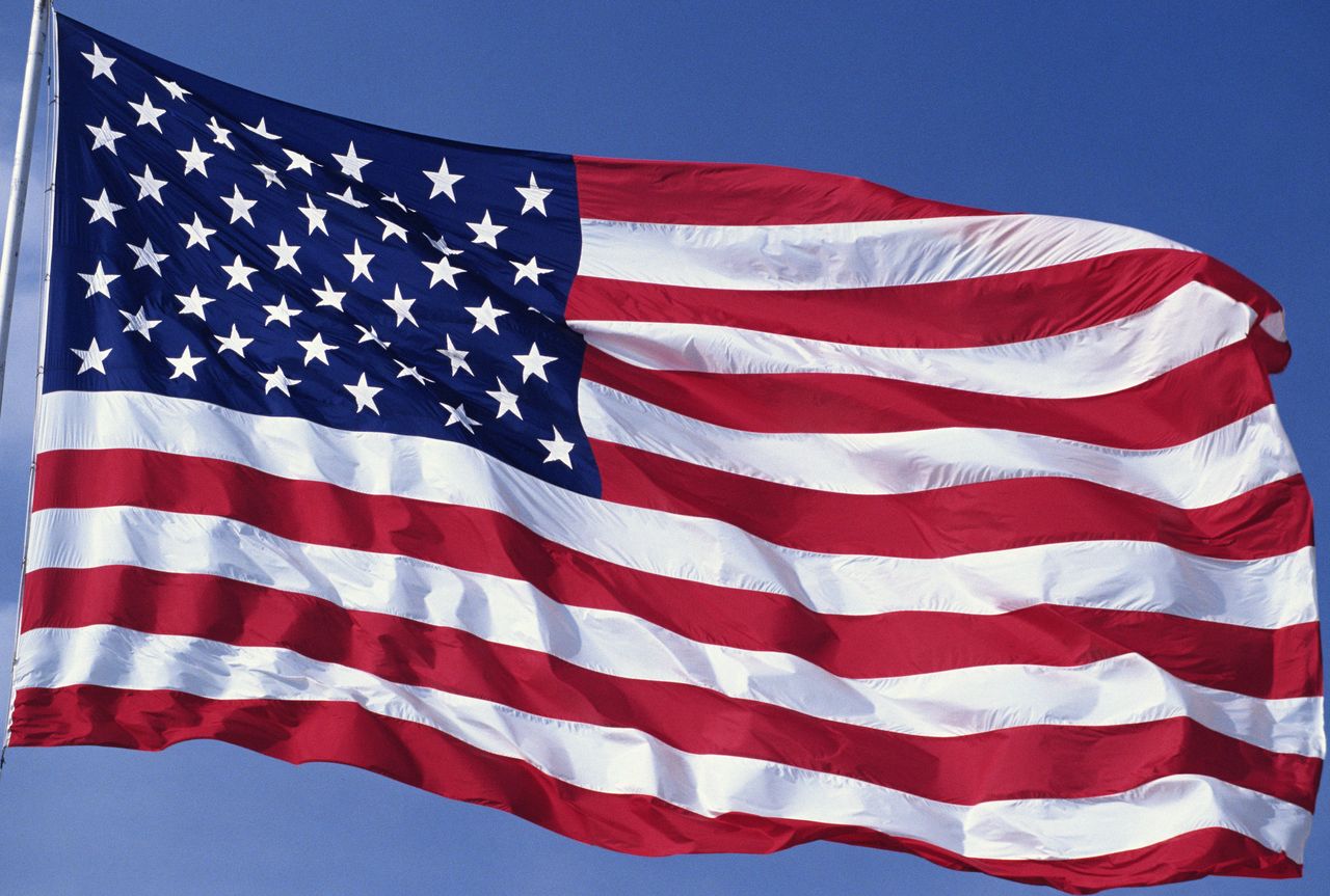 American flag with blue sky in the background