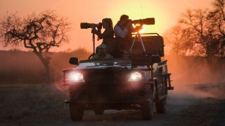 Photographers taking pictures from an all terrain vehicle