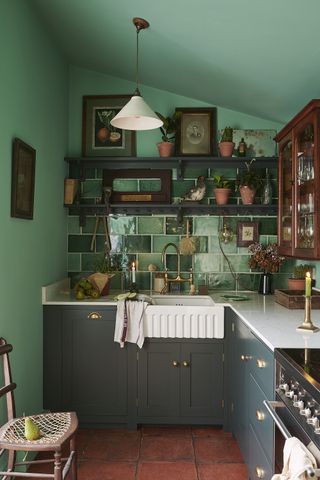 Small dark green kitchen by deVOL
