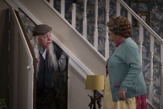 Grandad hiding under Mrs Brown's stairs while she tries to coax him out.