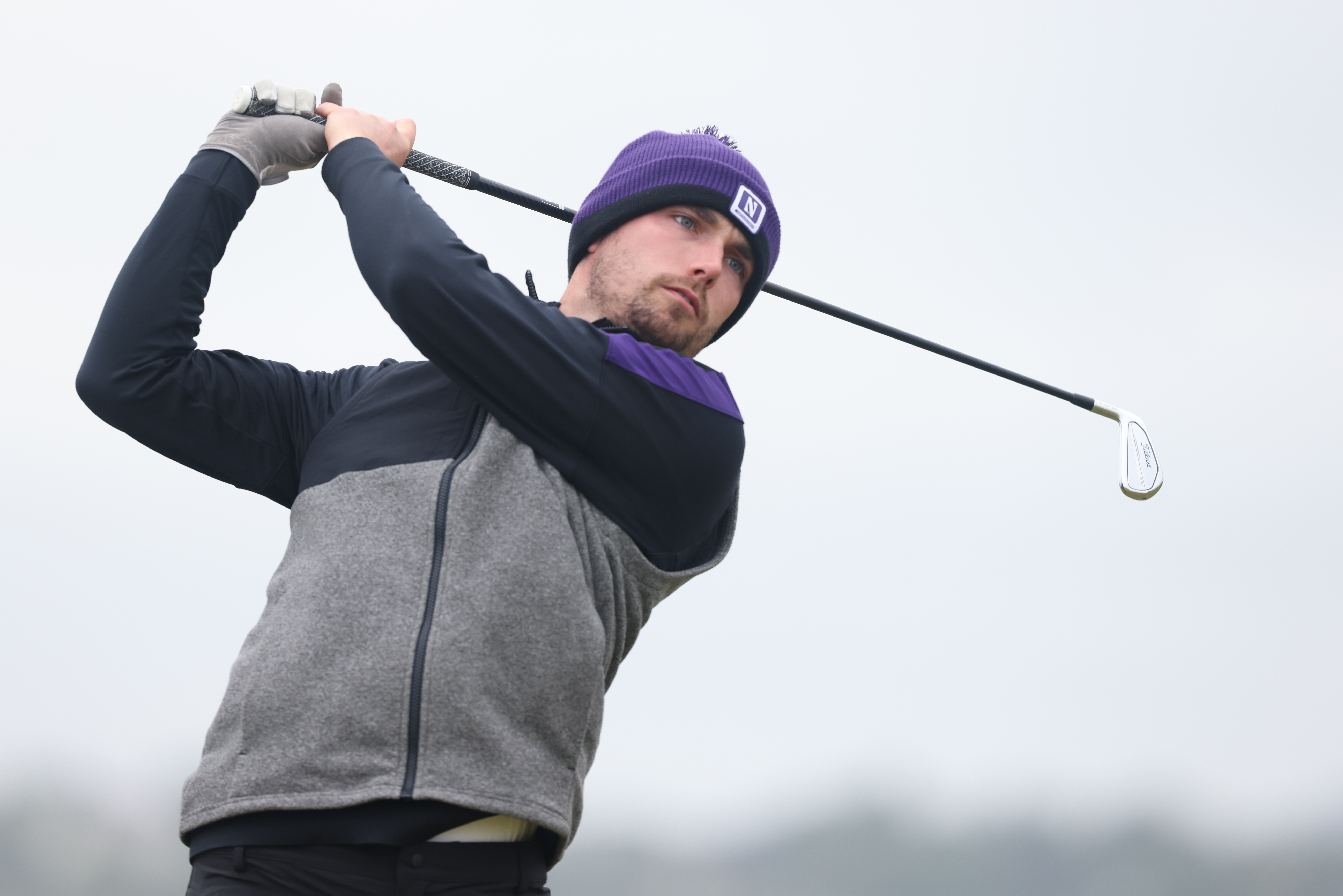 Cameron Adam hits a tee shot with an iron