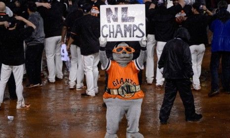 Mascot Lou Seal holds up a sign reading &amp;#039;NL Champs&amp;#039; after the Giants defeat the St. Louis Cardinals 9-0 to advance to the World Series. 