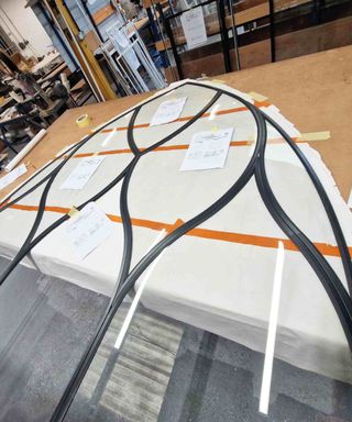 A large piece of secondary glazing, by Storm Windows, being created for a church conversion in a workshop.