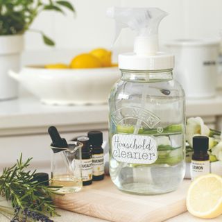 A natural cleaning spray made with a mason jar and essential oils