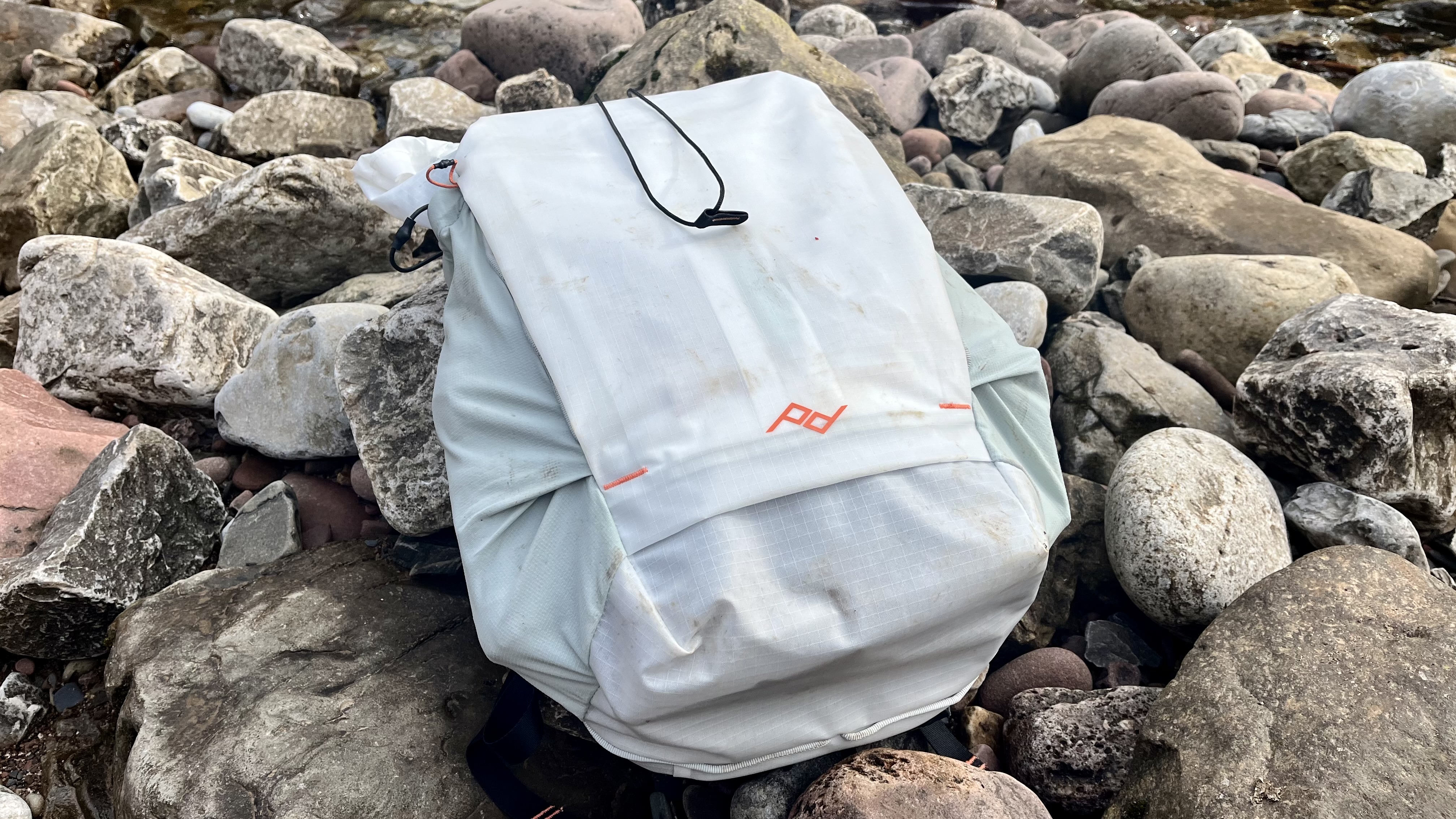 peak design outdoor backpack on stones