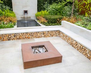 sunken patio with built-in benches and water feature
