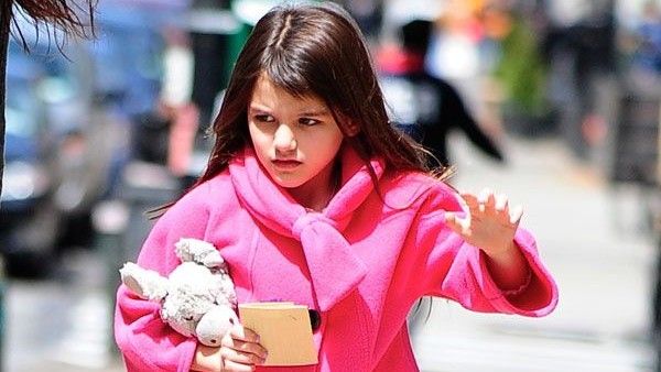 Suri Cruise in a pink coat.