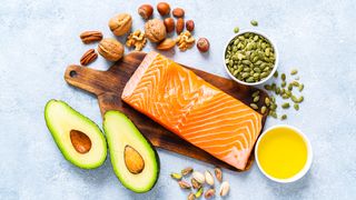 A photo of healthy fats, including oily fish, avocados and olive oil