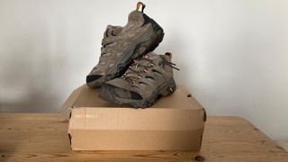 Muddy Merrell Moab 3 shoes on cardboard box