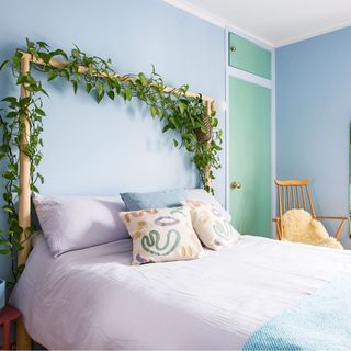 green bedroom with wooden bed