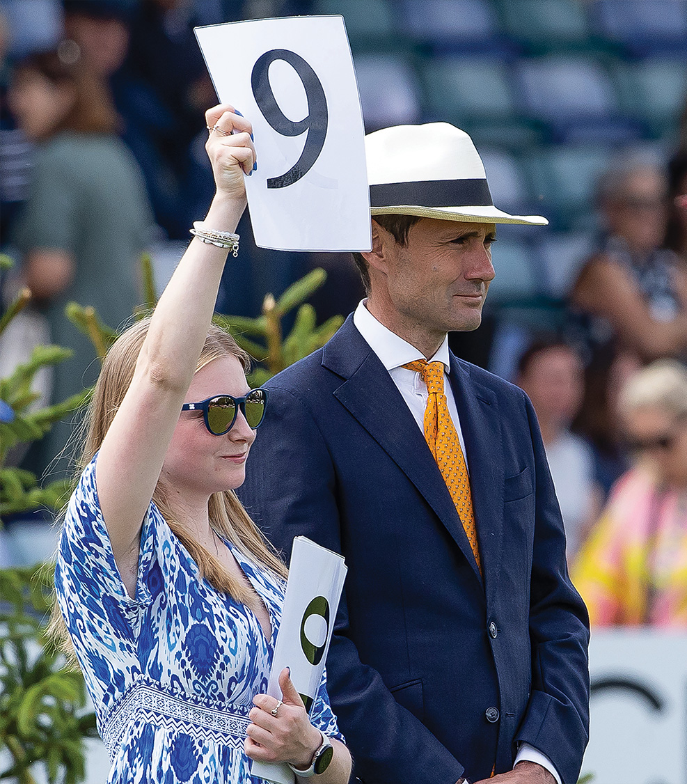 Showing judge holding mark of 9 up for spectators and competitors to see