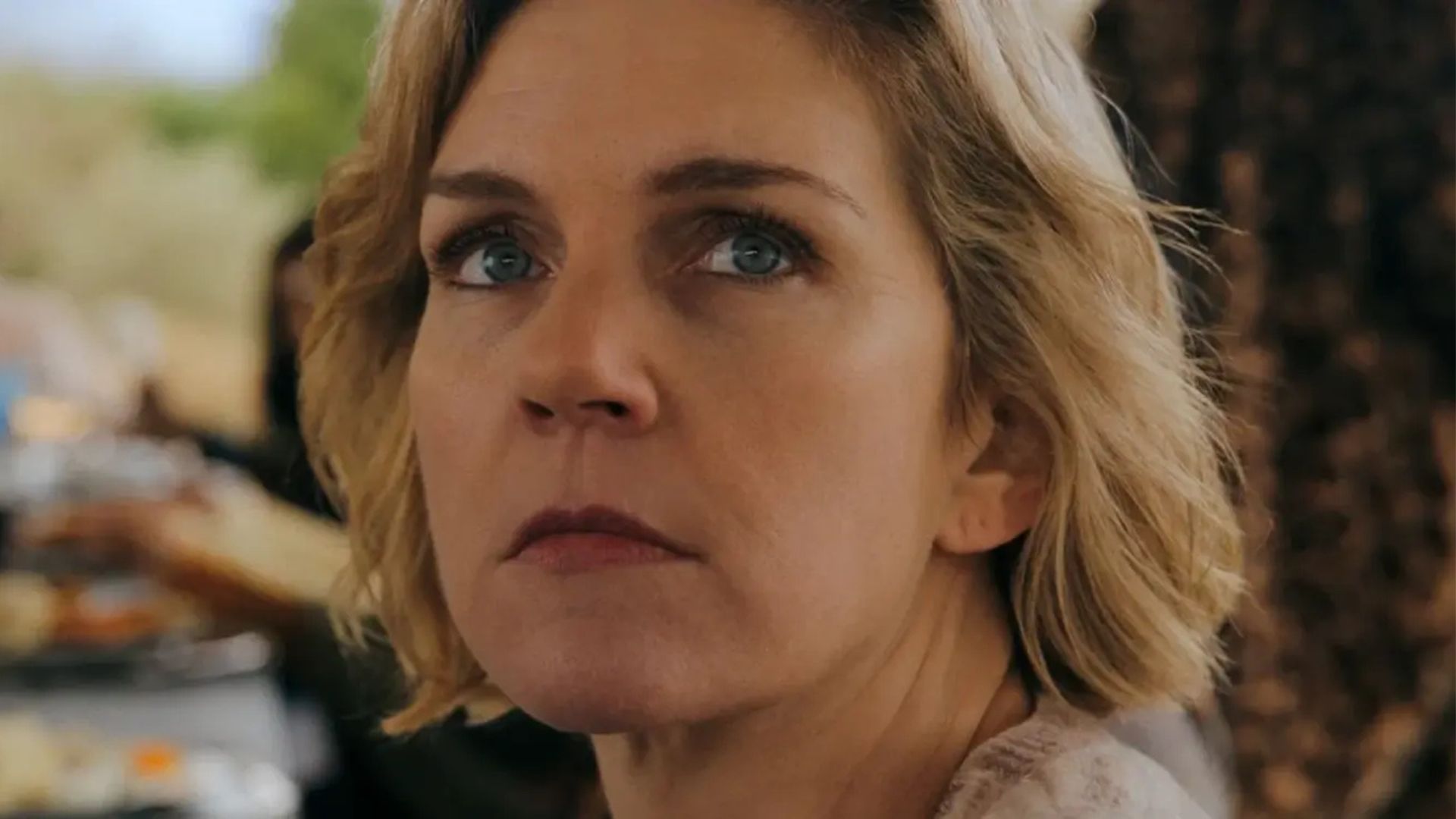 Carol stares at something offscreen