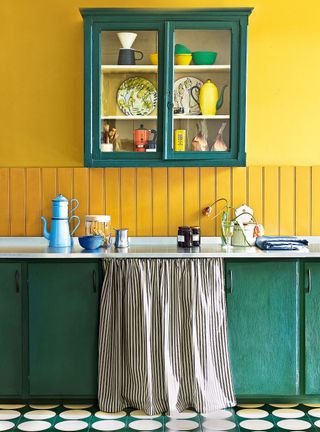 Kitchen with yellow painted wall and green painted cabinets